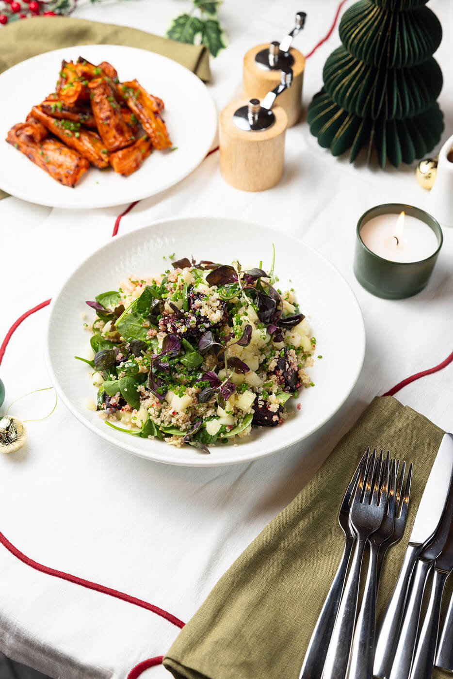Festive grain salad with herbs and greens in a white bowl.